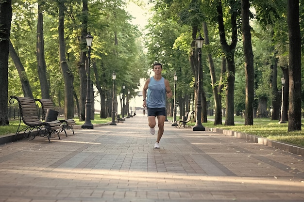 Athletic man runner with fit body running in sportswear outdoor