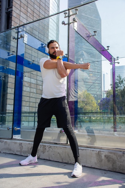 Athletic man stretching in the street