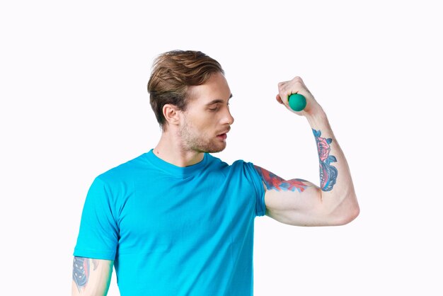 Athletic man with inflated arm dumbbell biceps workout