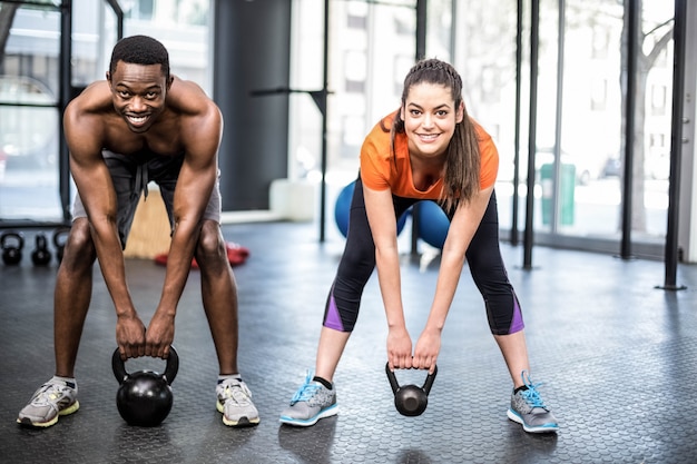 Athletic man and woman working out at gym