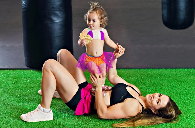 Athletic mother with her little daughter