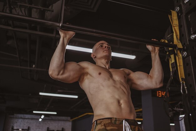 Фото Атлетик мускулистый мужчина упражнения в тренажерном зале
