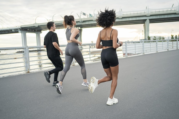 Athletic people in sportswear are engaged in fitness runners are training A man and a woman