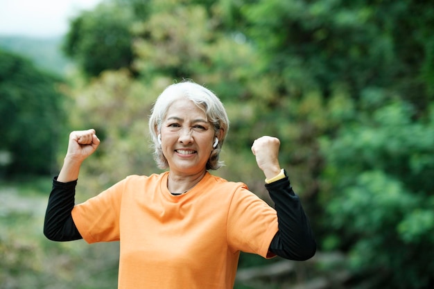 公園で腕を伸ばす運動シニア女性