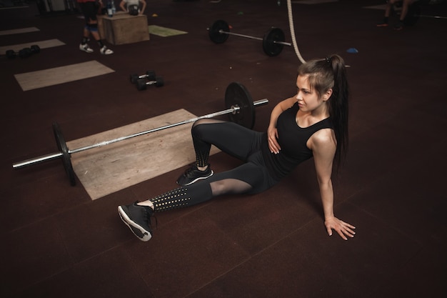 Athletic woman exercisign at functional training gym