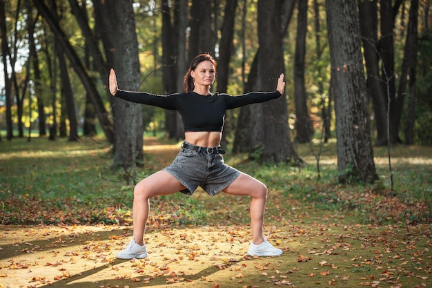 Athletic woman performing Rudrasana exercise a power asana to strengthen leg muscles exercising