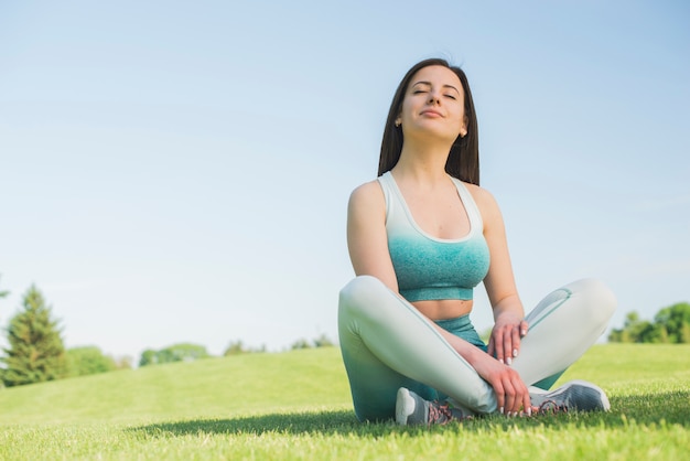 Athletic woman practicing yoga outdoor