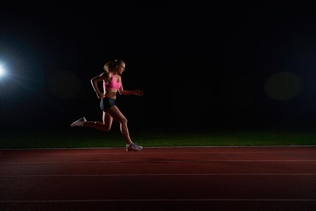 Athletic woman running onrace  track