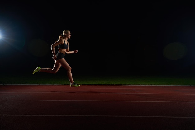 Athletic woman running onrace  track