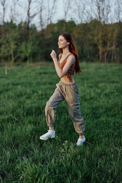 An athletic woman runs and trains her body before the summer season in the park