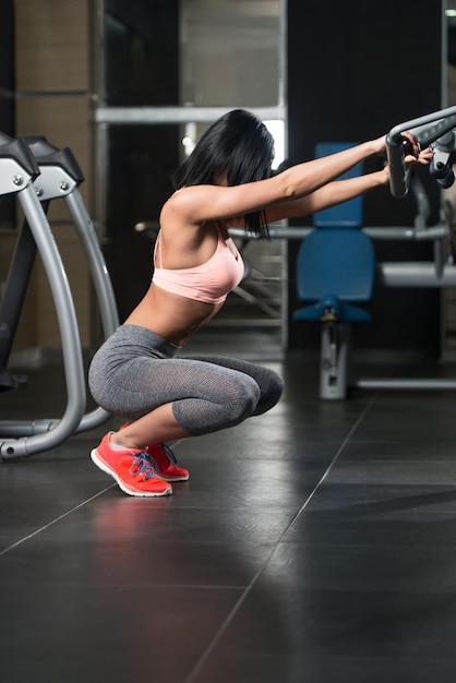 Athletic Woman Stretches In Gym