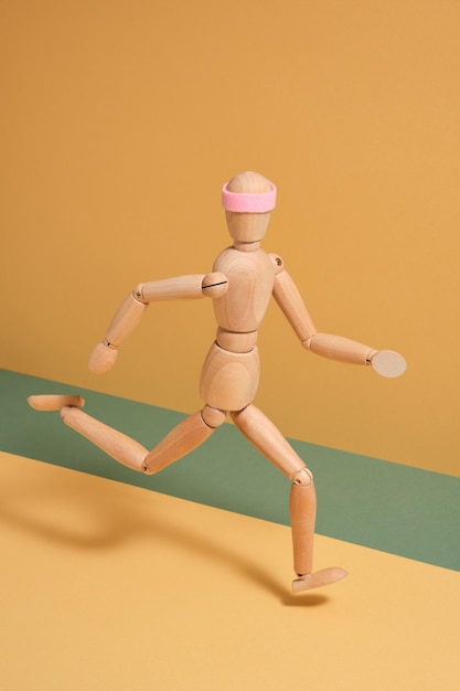 Photo athletic wooden man fast run with headband pink color body shadow falls on yellowgreen background aesthetic of dynamic sport movement