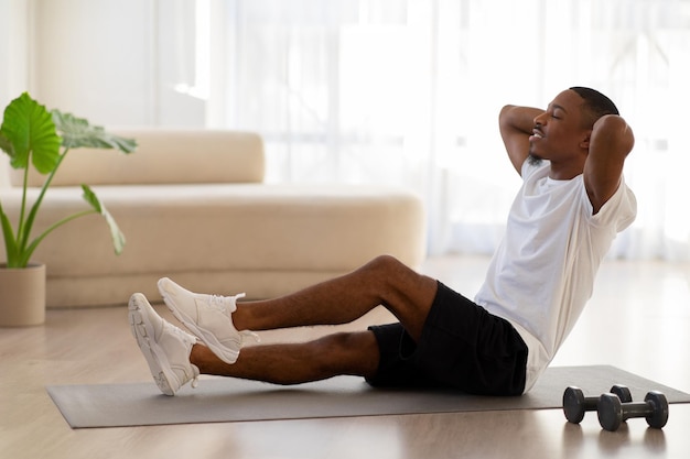 Athletic young african american man doing workout at home