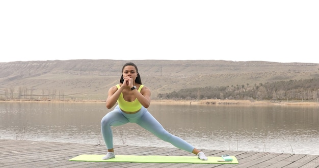 Athletic young black woman in sports dress doing fitness exercise.