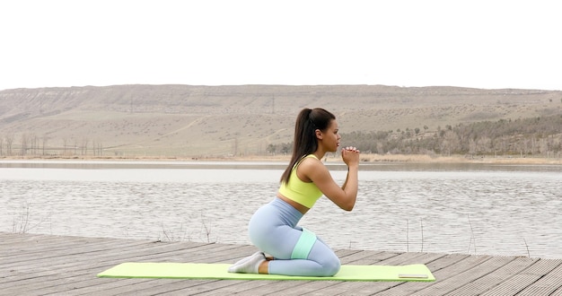 Athletic young black woman in sports dress doing fitness exercise.