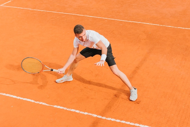 Athletic young boy playing tennis