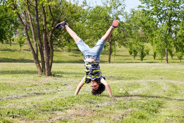 Athletic young boy practicing hand stands