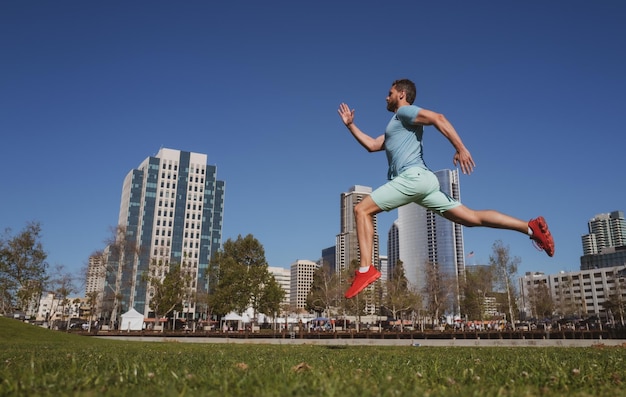 Athletic young man running in city san diego urban sport concept