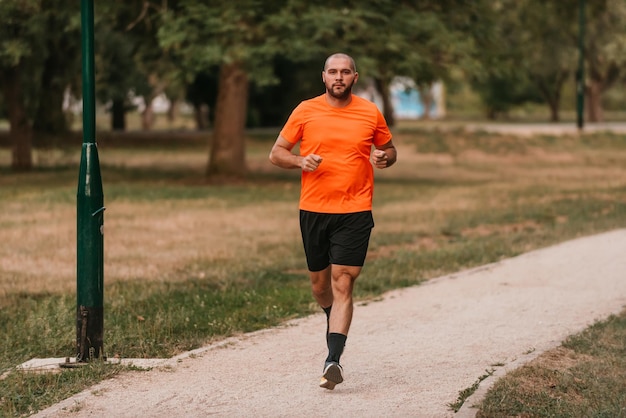 Athletic young man running in nature Healthy lifestyle