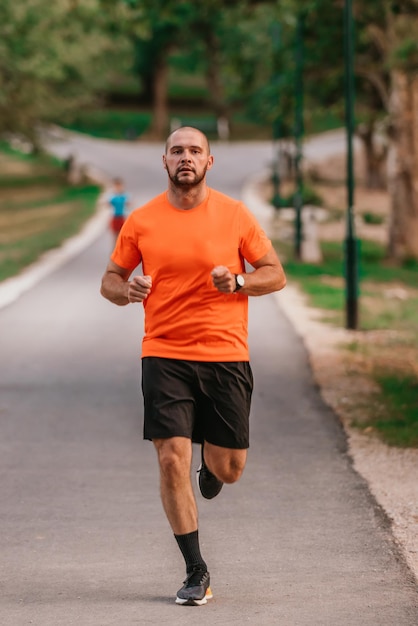 Athletic young man running in nature Healthy lifestyle