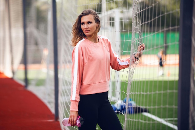 Athletics girls in the stadium do exercises