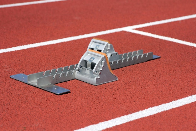 Athletics starting blocks on race red track