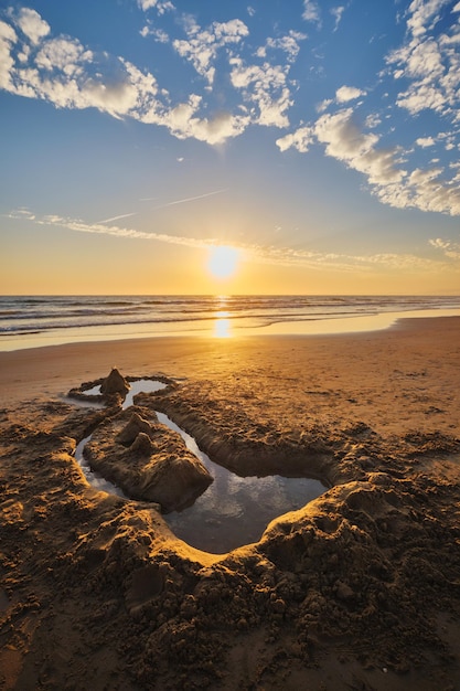 Atlantic ocean sunset with surging waves at fonte da telha beach portugal