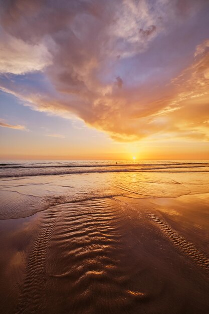 Atlantic ocean sunset with surging waves at fonte da telha beach portugal