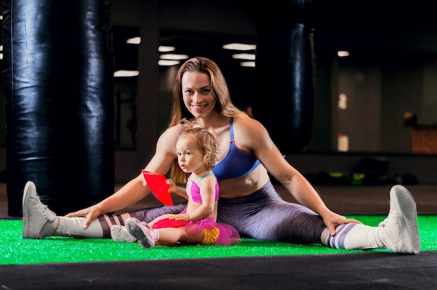 Atletische vrouw met lang haar poseren met meisje