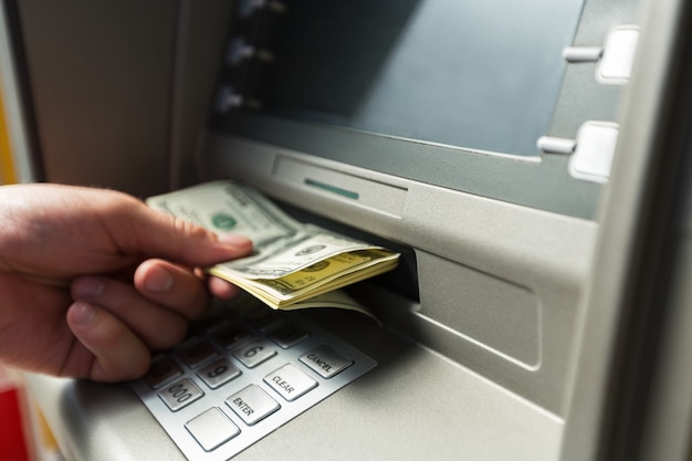 Atm bank banking paper currency bank teller removing currency