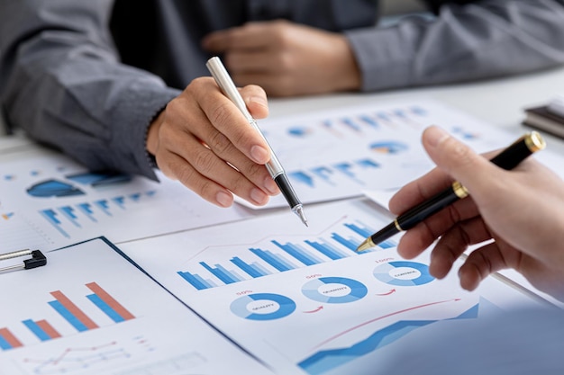 The atmosphere in the meeting room where the businessmen are meeting information papers and charts are placed on the table to support the business planning meeting to grow Business idea