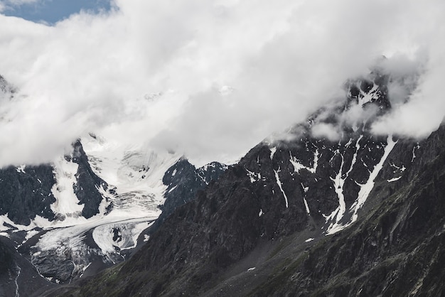 Atmospheric alpine landscape with massive hanging glacier on giant mountain