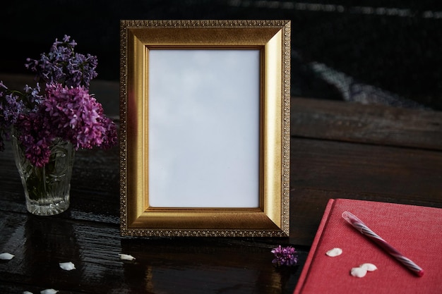 Atmospheric template picture frame and lilac flowers Pink notebook and pen