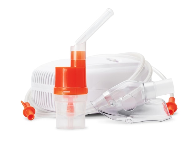 Atomizing cup with nebulizer mouthpiece and mask for compressor inhaler isolated on white background Medical equipment for inhalation therapy for asthma and respiratory diseases