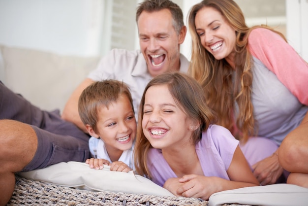 Photo attack of the tickle monsters. shot of a happy young family playing together.