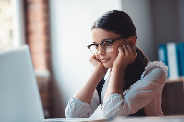 Attention. Surprised brunette girl in eyeglasses looking attentive