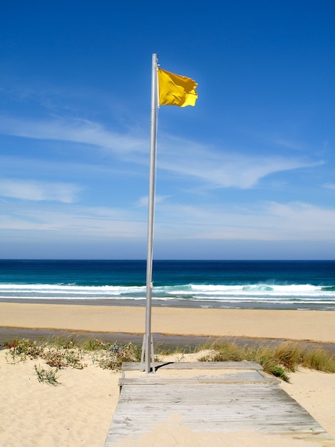 Attention, yellow flag on the beach