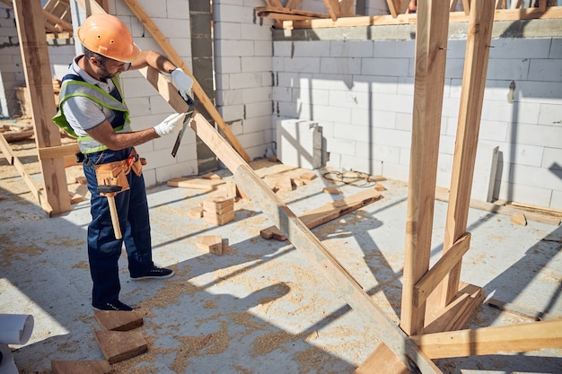 Attentive builder standing on the top floor