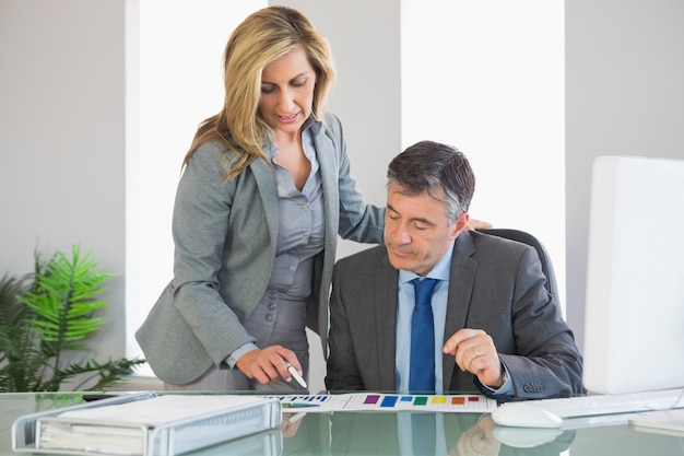 Attentive businesswoman explaining figures to a businessman