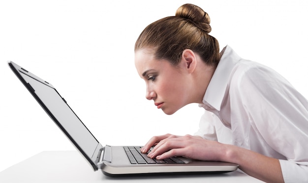 Attentive businesswoman typing on laptop