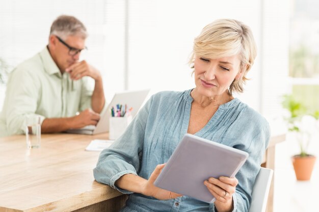 Attentive businesswoman working on a tablet