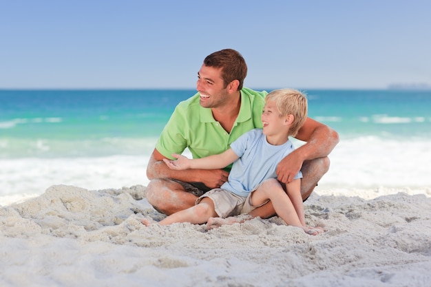 Attentive father with his son at the beach