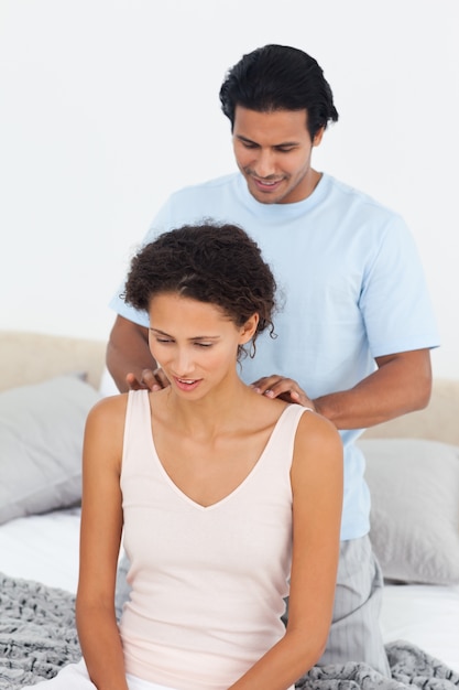 Attentive man doing a massage to his beautiful wife 