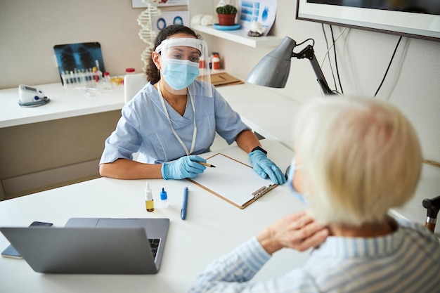 Attentive medical specialist listening to person complaints