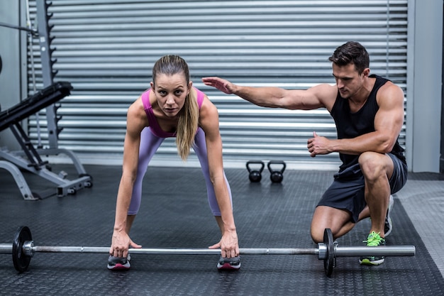 Attentive muscular woman lifting weight 