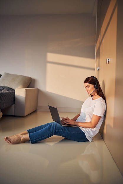 Attentive operator staring at her laptop during work