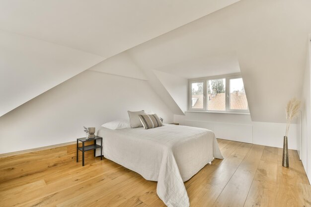 an attic bedroom with a bed and a window