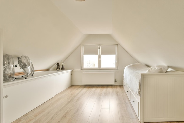 An attic bedroom with a bed and a window