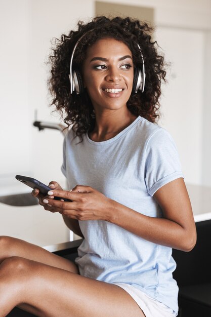 Attractive african woman in headphones