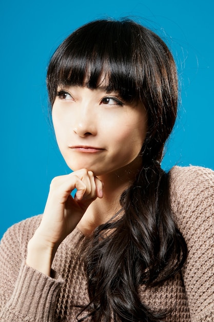 Attractive Asian beauty thinking, closeup portrait